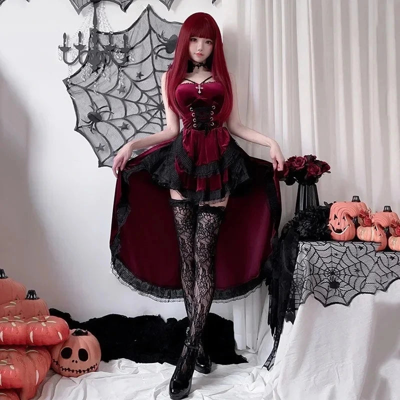 Person in a gothic outfit with Halloween decorations including pumpkins and spider webs.